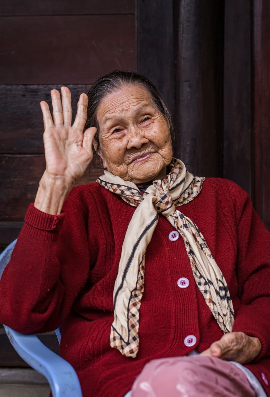 A warm portrait of an older Asian woman smiling